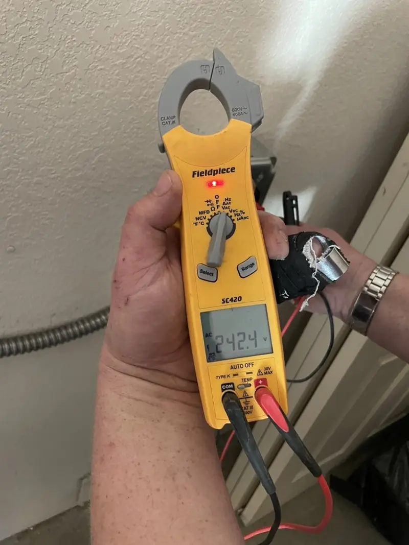 Voltage testing with clamp meter during Recessed Lighting Installation in Strasburg
